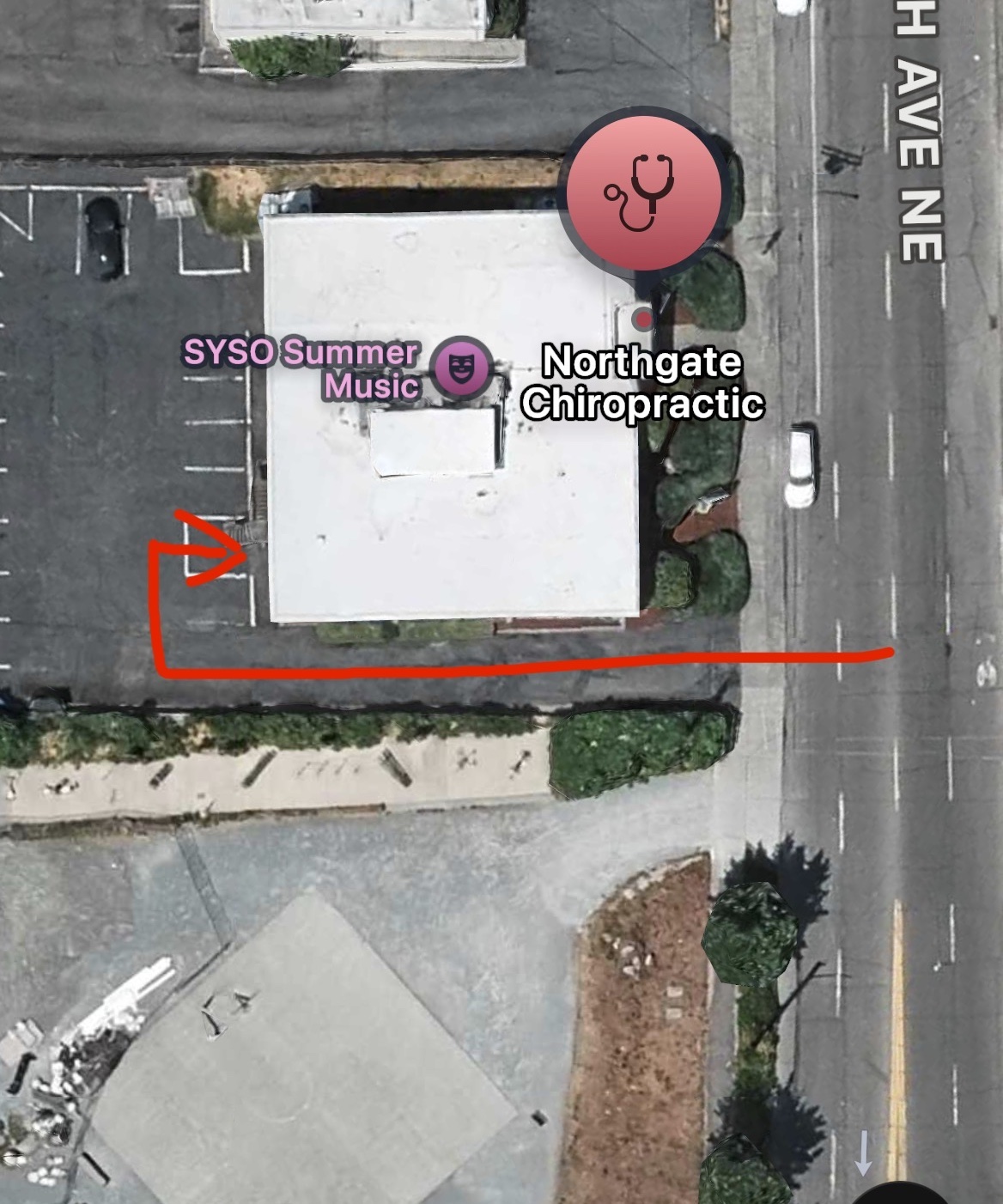 Aerial map view of Northgate Chiropractic with a red arrow marking the rear driveway entrance on 5th Ave NE